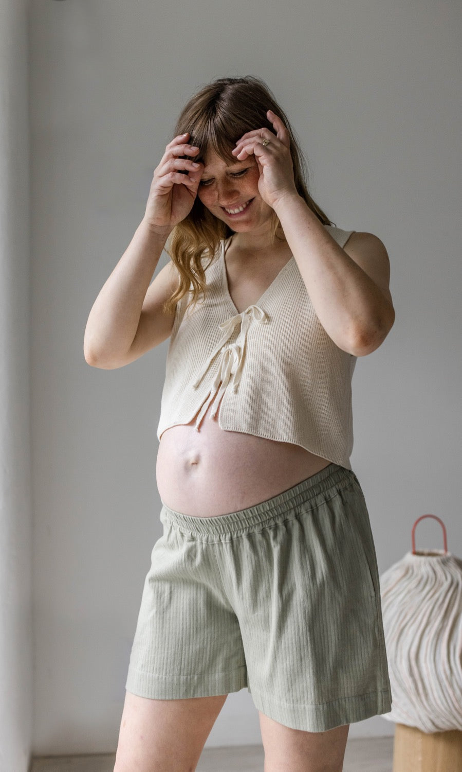 Umstandsshorts Jeanne in hellgrün kombiniert mit hellem Strickpullunder